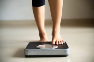 Person stepping on scale - Weight Wise Weight Loss Center Person Stepping On Scale