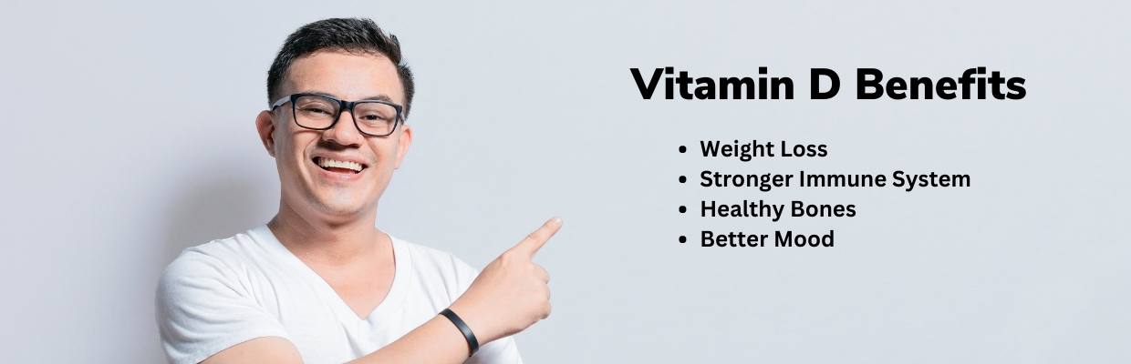 A smiling man pointing to a list of the benefits of vitamin d