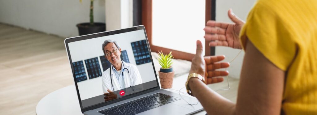 a doctor talking to a patient on the computer